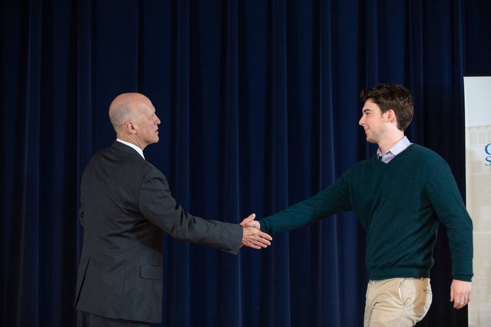 Thomas Finn shaking hands with Dr. Potteiger.